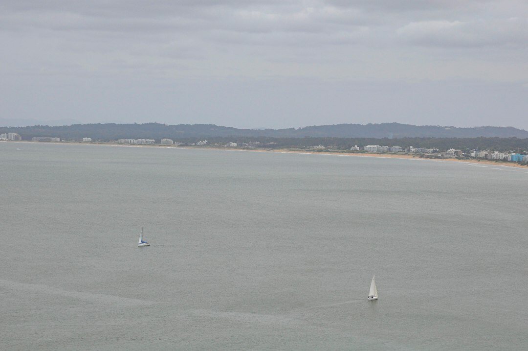 Sailboats competing in a regatta near La Barra, Punta del Este, at sunset