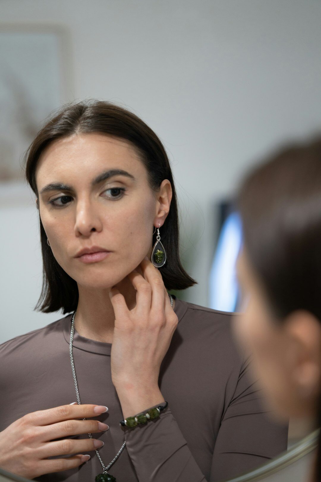 elegant woman trying on jewelry
