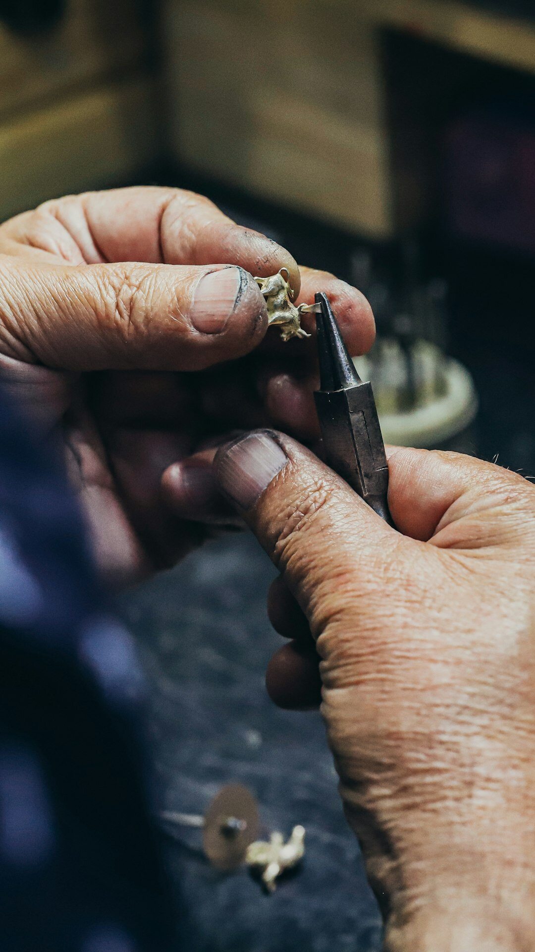 Watchmaker's hands assembling a Swiss watch movement with tweezers