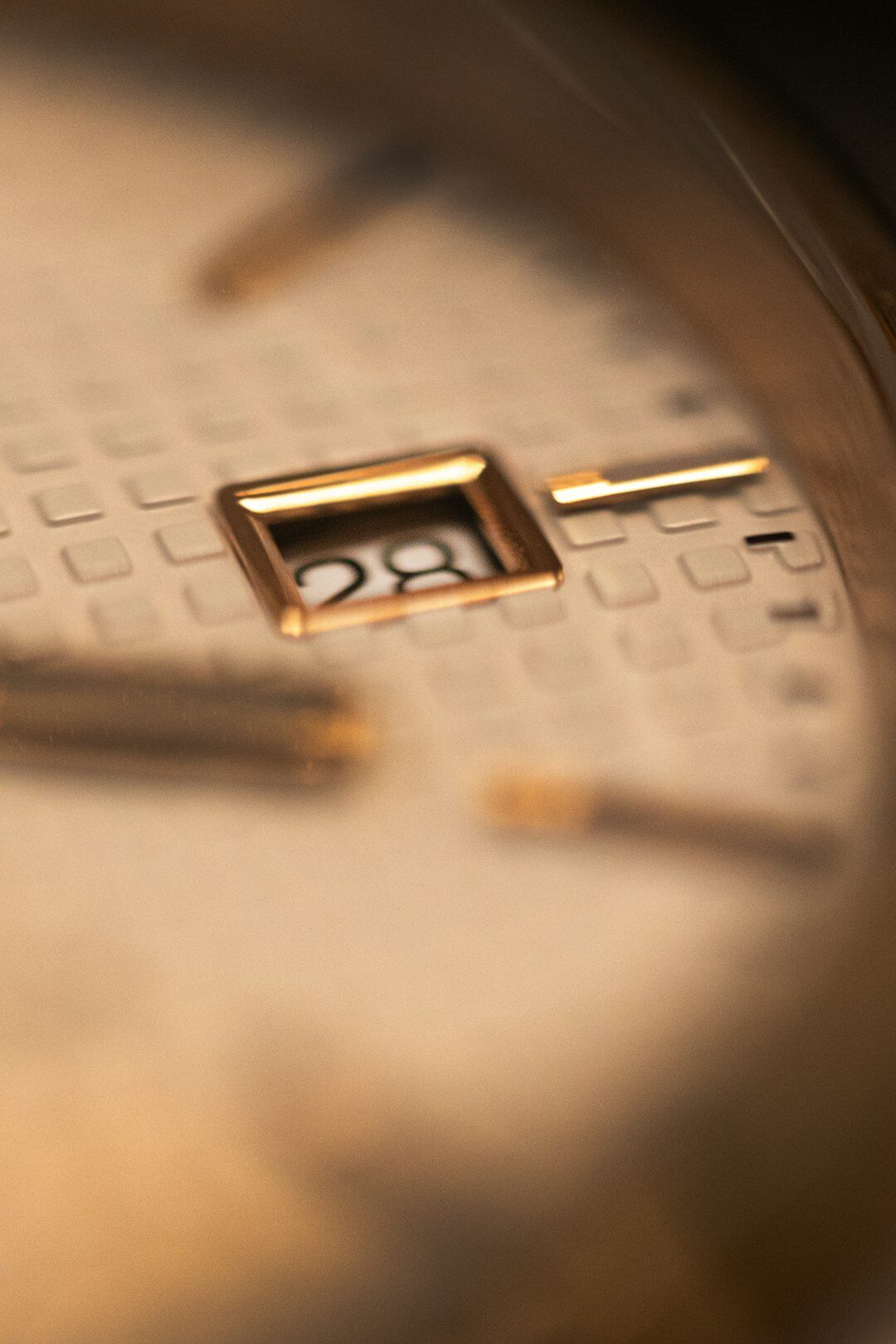 Macro close-up of a Swiss tourbillon watch movement with gold bridges